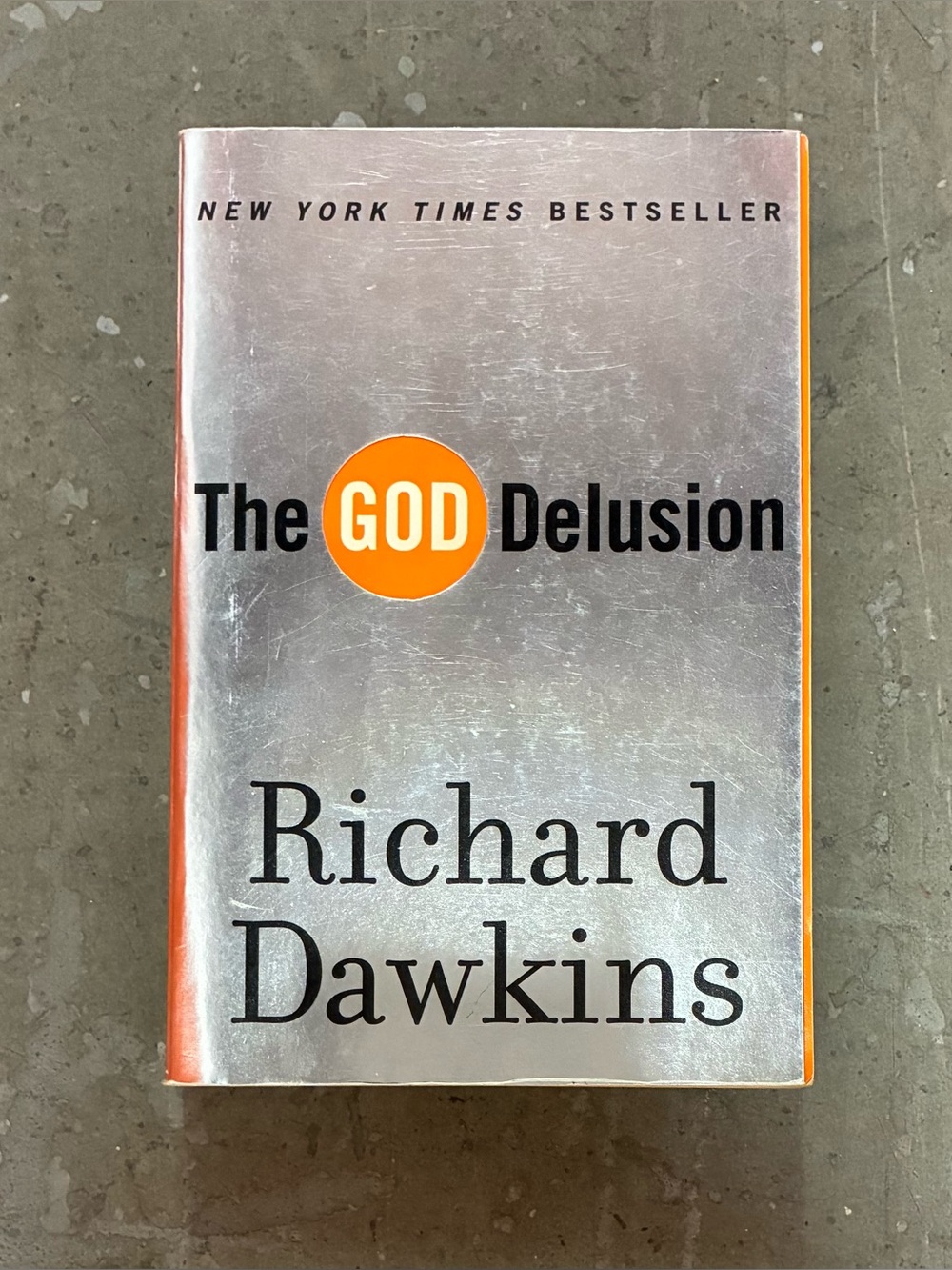 The God Delusion by Richard Dawkins - Silver & Orange Softcover